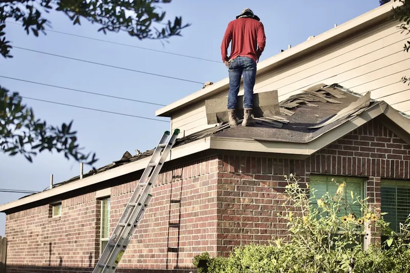 Professional roofer working on a residential roof in Desert Palms
